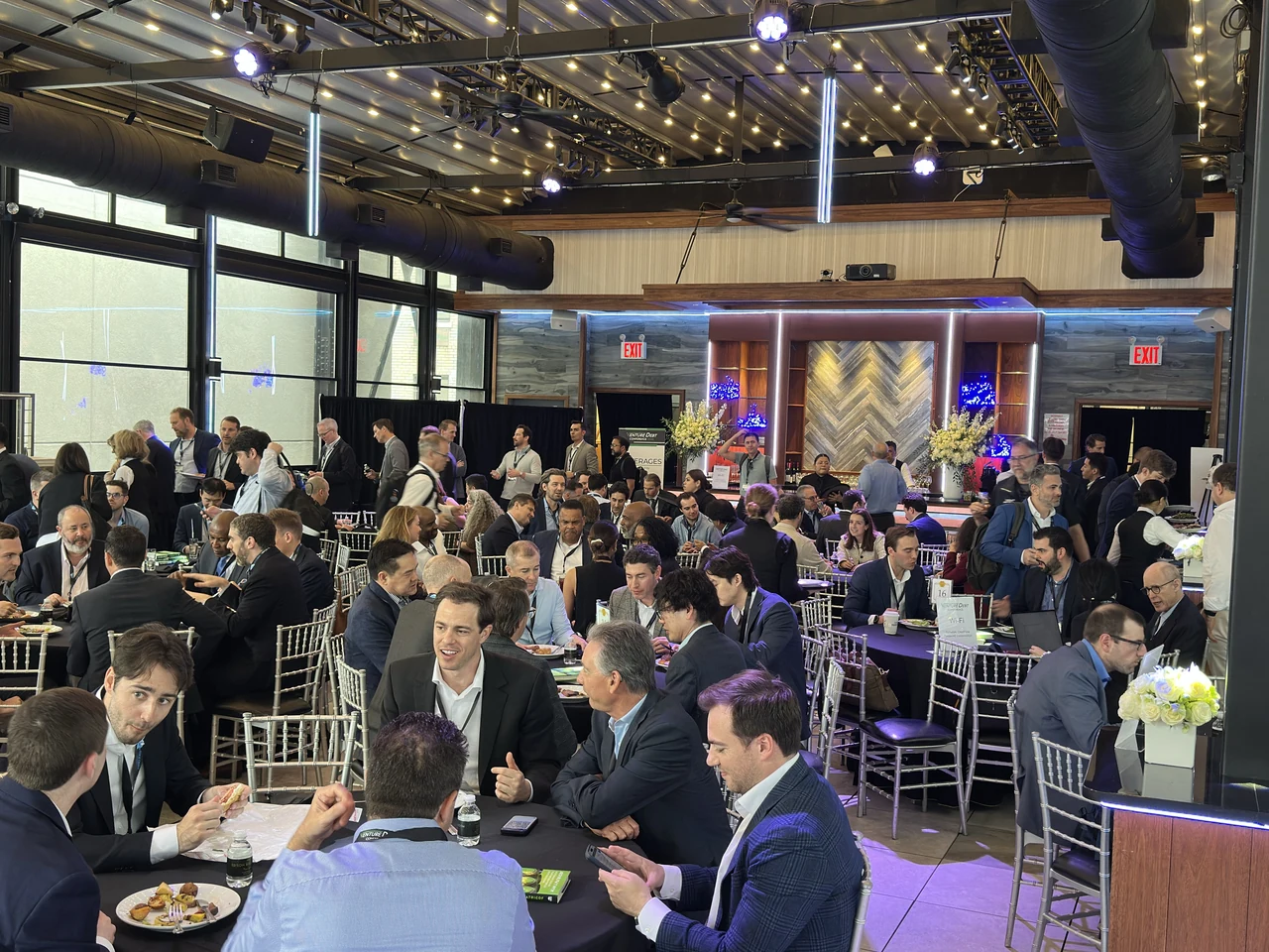 Groups of attendees meeting around tables during the 2026 Venture Debt Conference